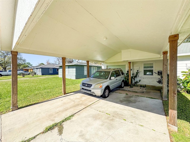 garage featuring a carport and a yard