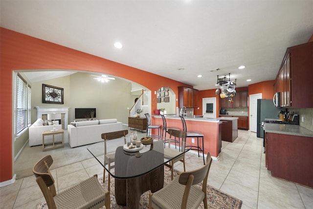 dining area with ceiling fan and light tile patterned flooring