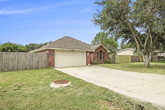 ranch-style home featuring a front lawn and a garage