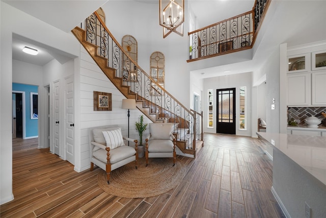 foyer entrance with a chandelier and a high ceiling