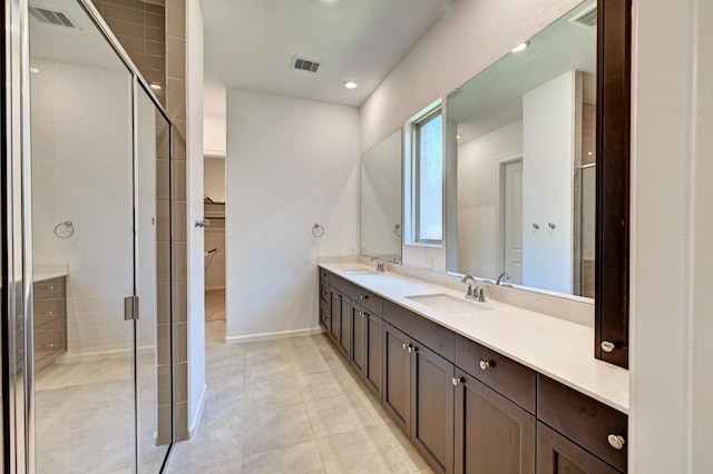 bathroom featuring vanity, tile patterned floors, and a shower with door