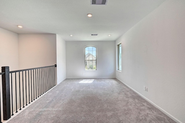 unfurnished room with light colored carpet