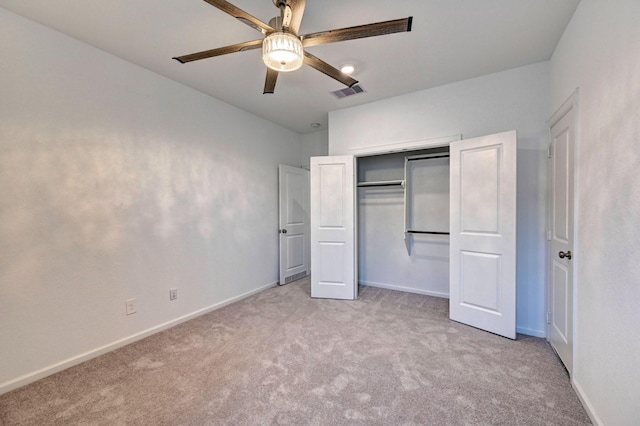 unfurnished bedroom with a closet, light colored carpet, and ceiling fan