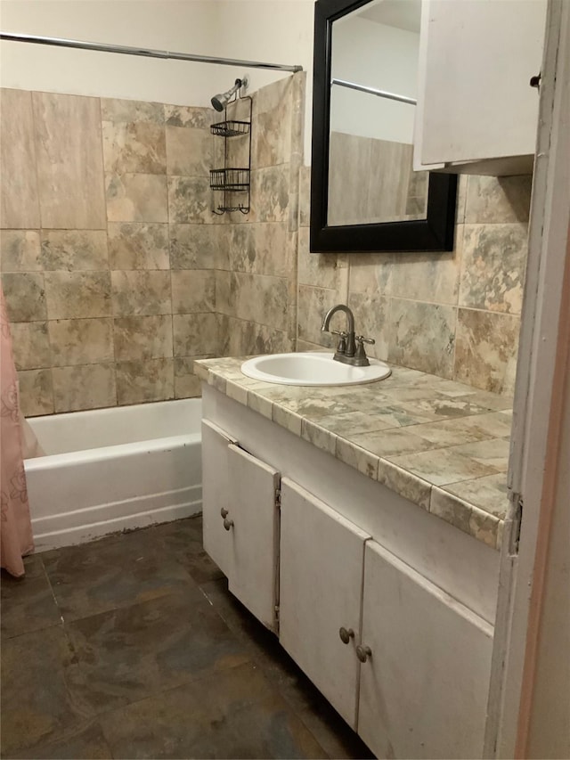 bathroom with shower / bath combo, vanity, and tasteful backsplash