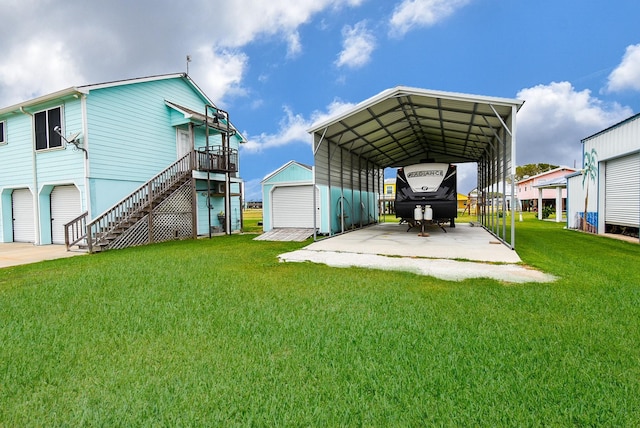 exterior space featuring a yard, a garage, and a carport