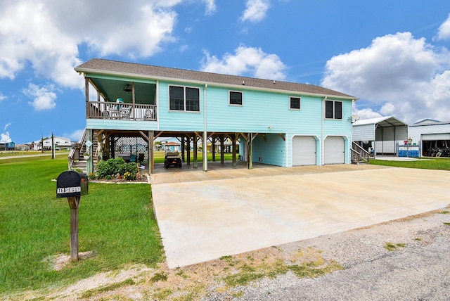 view of front of home featuring ceiling fan, a front lawn, a carport, and a garage