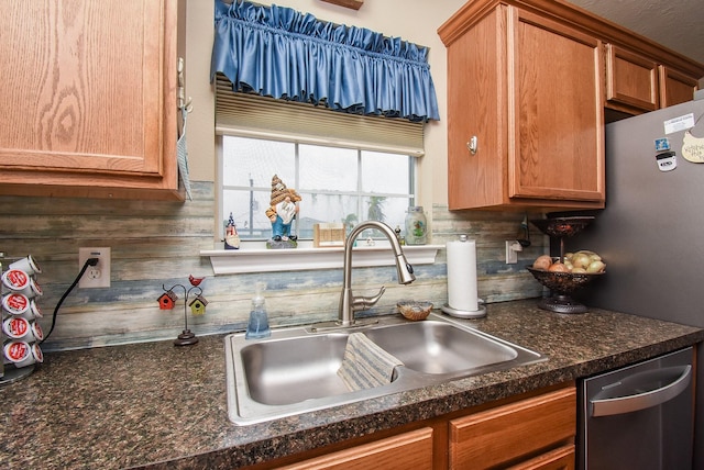 kitchen featuring backsplash, sink, and stainless steel dishwasher