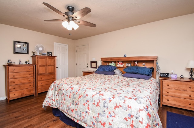 bedroom with dark hardwood / wood-style flooring and ceiling fan