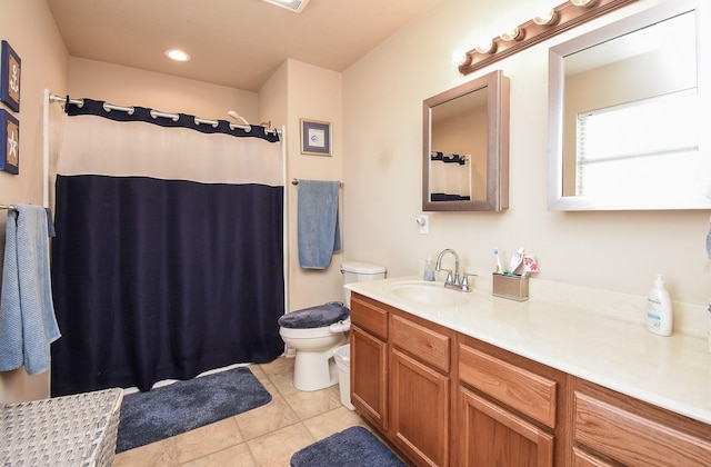 bathroom featuring tile patterned flooring, vanity, toilet, and curtained shower