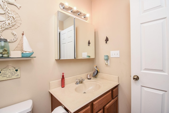 bathroom featuring vanity and toilet