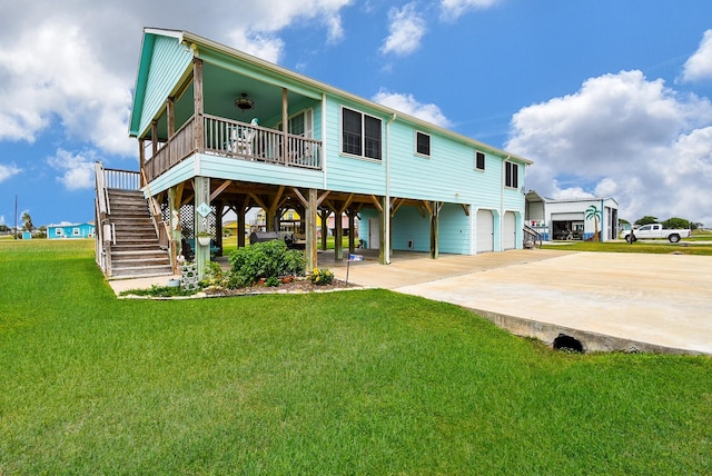 back of house with a yard, a garage, and a carport