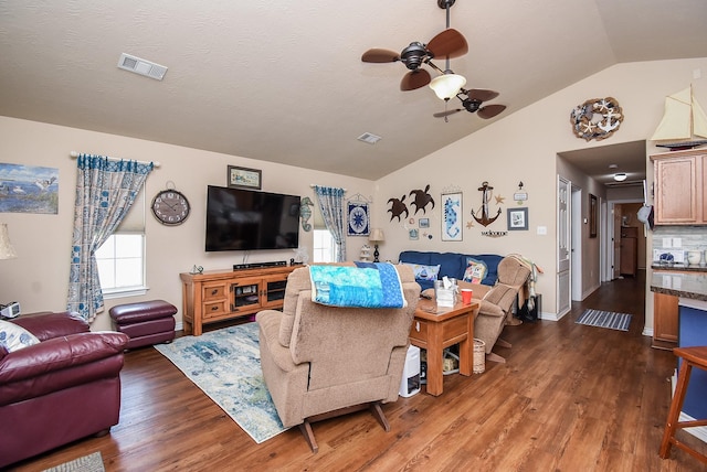 living room with dark hardwood / wood-style flooring, vaulted ceiling, and ceiling fan