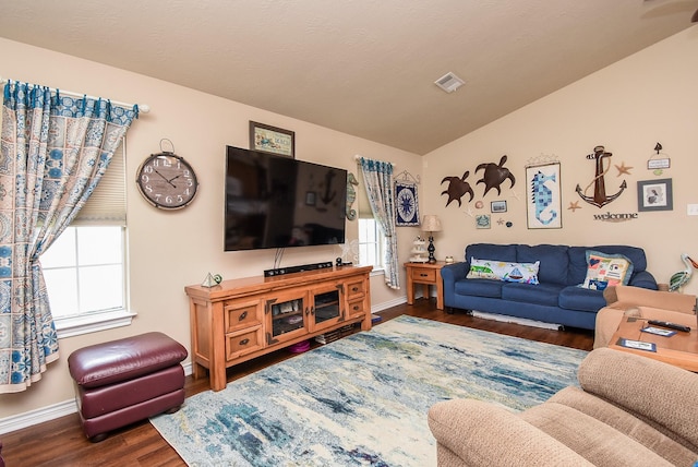 living room featuring lofted ceiling and dark hardwood / wood-style floors