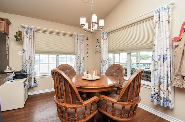 dining area with dark hardwood / wood-style flooring, lofted ceiling, and a chandelier