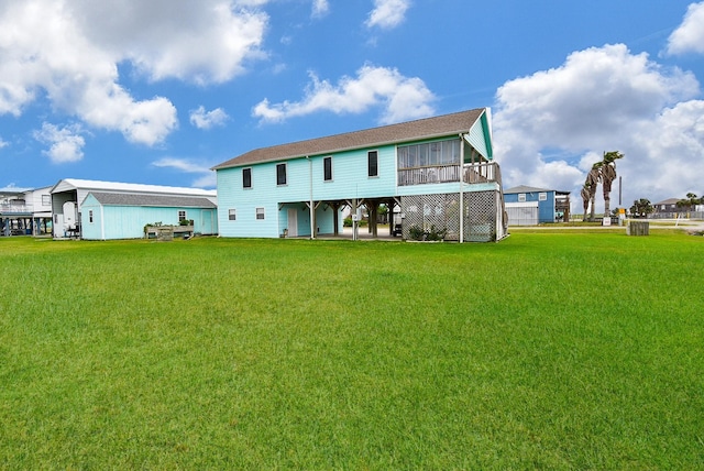 back of house with a sunroom and a lawn