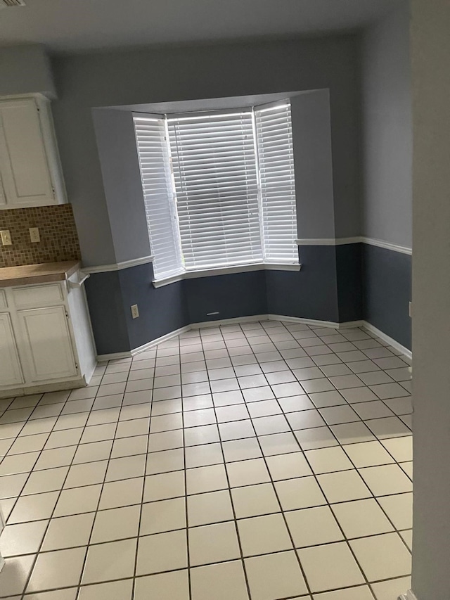 unfurnished dining area with light tile patterned floors