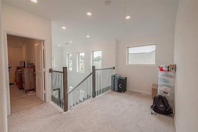 hall featuring light colored carpet