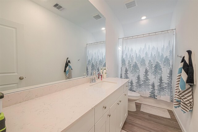 full bathroom featuring vanity, toilet, wood-type flooring, and shower / bath combo