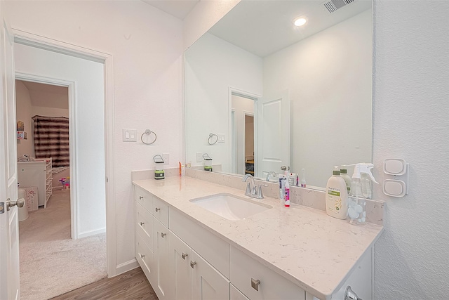 bathroom featuring vanity and wood-type flooring