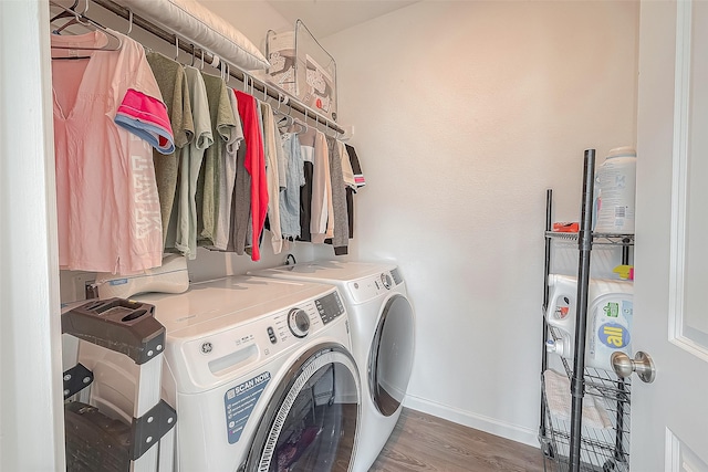 laundry area featuring washing machine and clothes dryer and dark hardwood / wood-style flooring