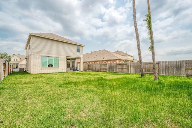 rear view of house featuring a lawn