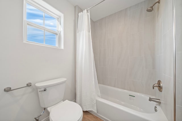 bathroom with toilet and shower / bathtub combination with curtain