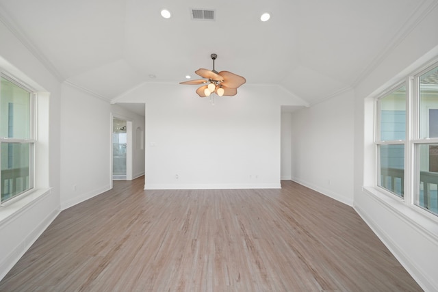 spare room with lofted ceiling, visible vents, and a wealth of natural light