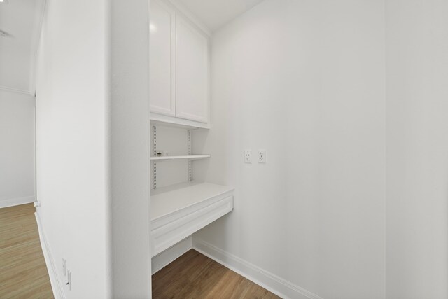 walk in closet with wood finished floors