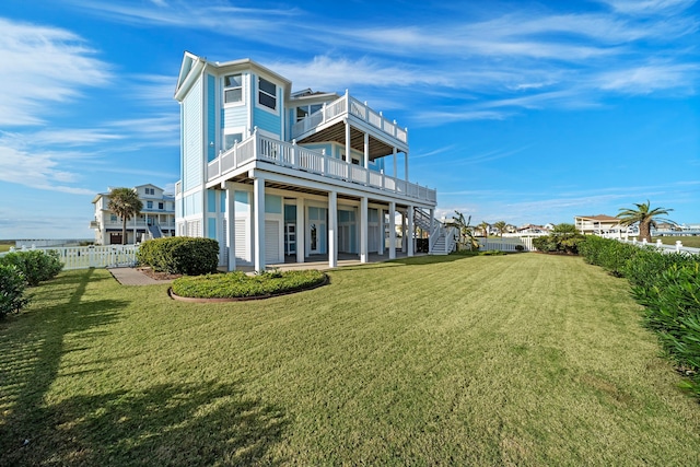 back of house with a lawn, a fenced backyard, stairs, and a patio area