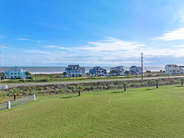 surrounding community featuring a lawn and a water view