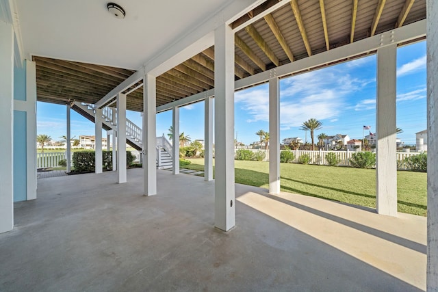 view of patio / terrace featuring stairs and fence