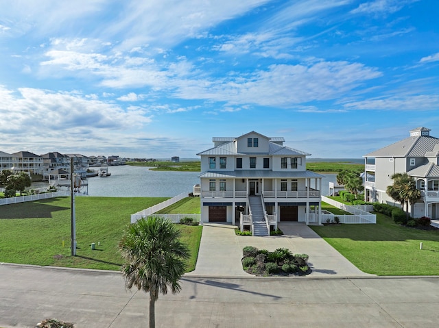 coastal inspired home with a porch, stairs, a front lawn, and a water view