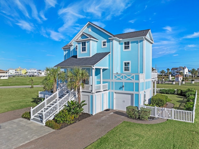 beach home with covered porch, stairs, a front yard, and fence