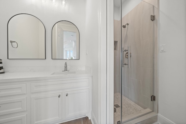 full bathroom with vanity and a stall shower