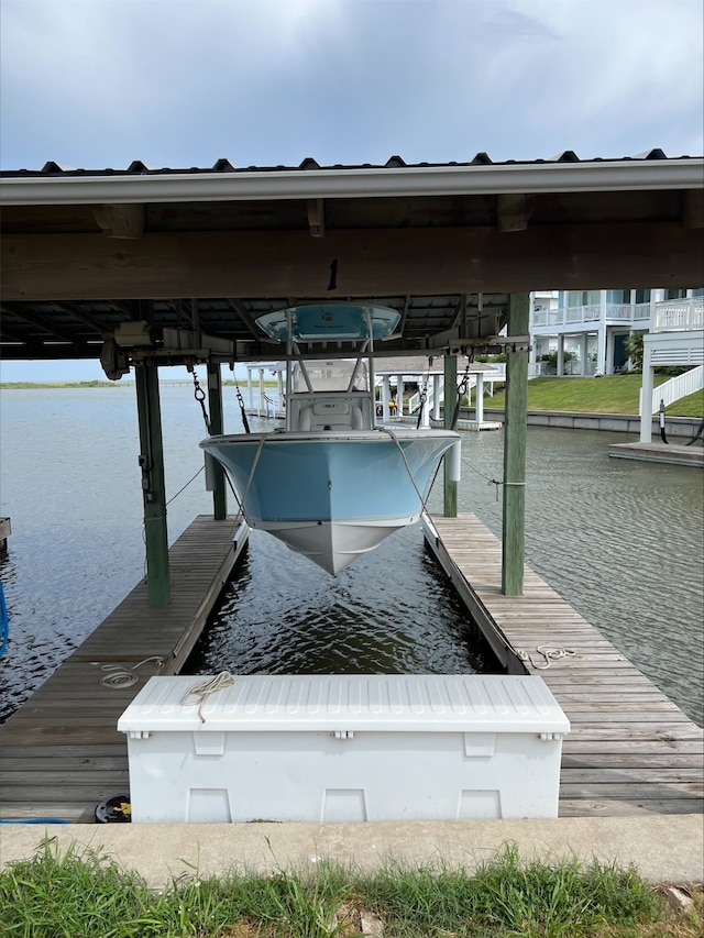 view of dock featuring boat lift and a water view