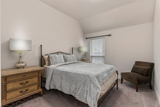 bedroom with carpet floors and vaulted ceiling