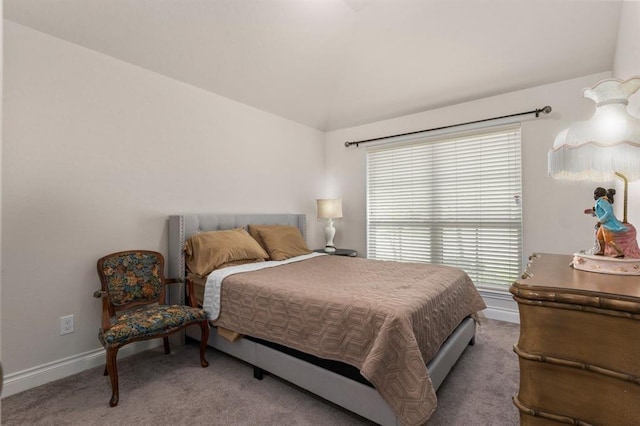 carpeted bedroom featuring lofted ceiling and multiple windows