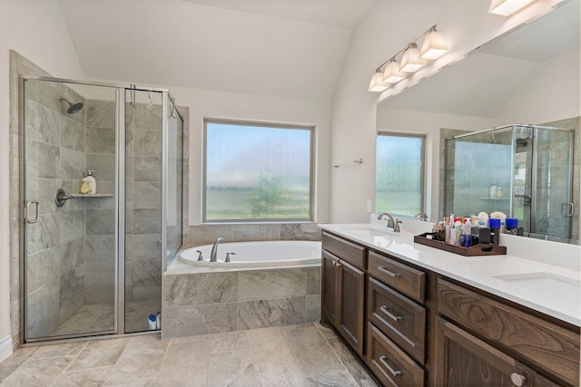 bathroom featuring shower with separate bathtub, vanity, and lofted ceiling