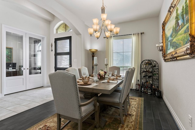 dining area featuring a healthy amount of sunlight, light hardwood / wood-style flooring, and french doors