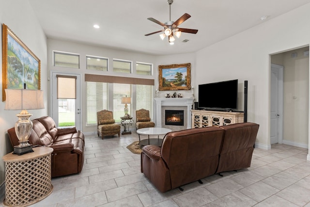 living room with ceiling fan and light tile patterned flooring