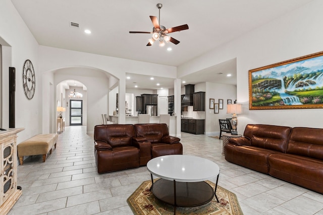 tiled living room with ceiling fan