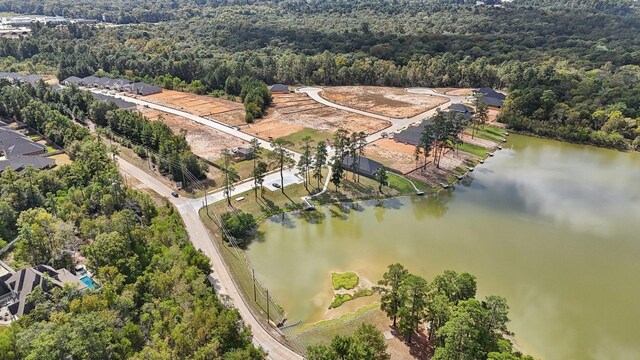 drone / aerial view featuring a water view and a view of trees