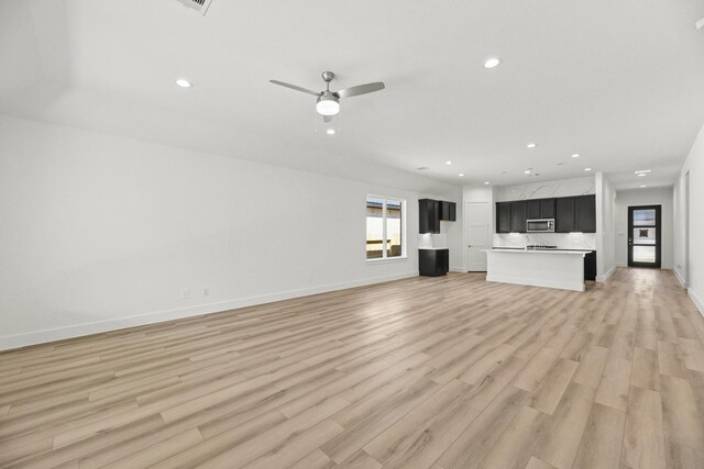 unfurnished living room featuring recessed lighting, light wood-type flooring, baseboards, and a ceiling fan