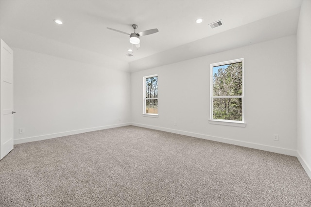 empty room with visible vents, recessed lighting, baseboards, and carpet