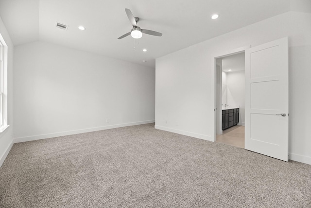 interior space featuring recessed lighting, visible vents, lofted ceiling, and light colored carpet