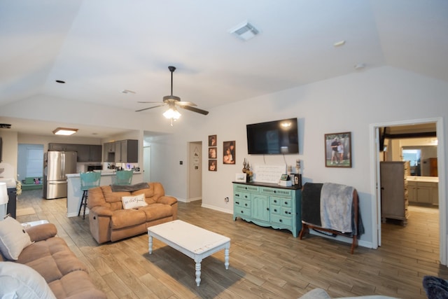 living room featuring light wood-type flooring, ceiling fan, and lofted ceiling