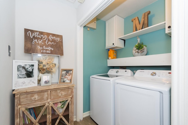 washroom with separate washer and dryer, cabinets, and hardwood / wood-style flooring