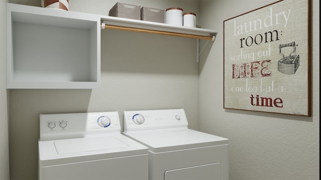 clothes washing area featuring washer and clothes dryer