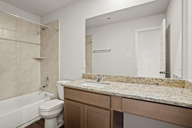 2321 Mooneye Ct, Conroe, TX 77384 - full bathroom with tiled shower / bath combo, toilet, vanity, and hardwood / wood-style floors