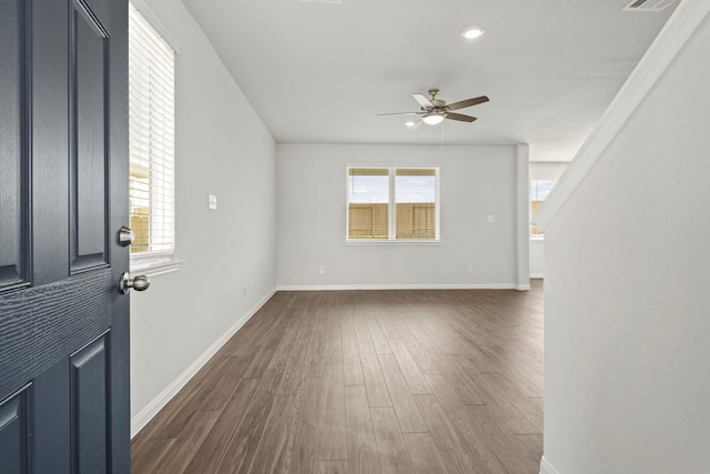 interior space with ceiling fan and dark hardwood / wood-style floors